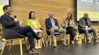 Speaker and 4 panelist on a stage.